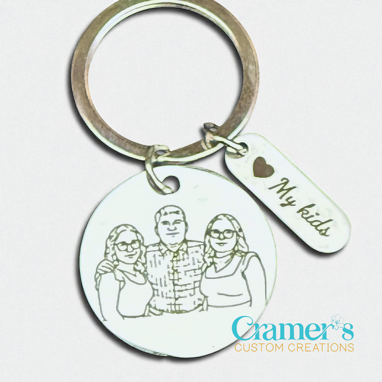 Keychain with engraved family photo and 'My kids' tag on a light background