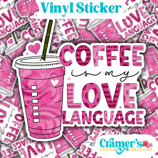 Sticker laying flat that says coffee is my love language on a background of the same sticker stacked up