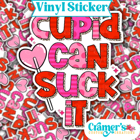 Sticker laying flat that says cupid can suck it with a lollipop on a background of the same sticker stacked up