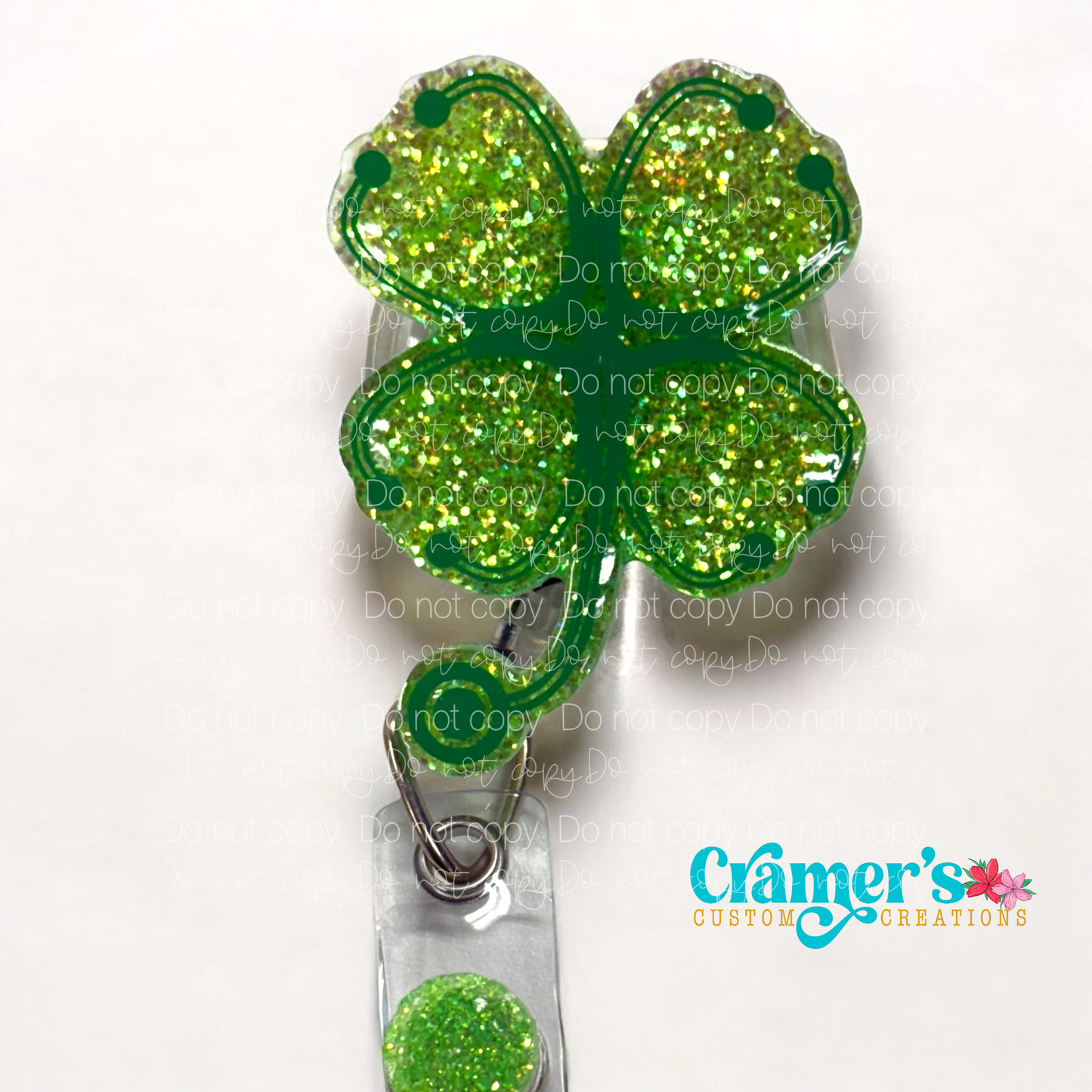 badge reel showing a green glitter background with stethoscopes made into a shamrock in darker green vinyl