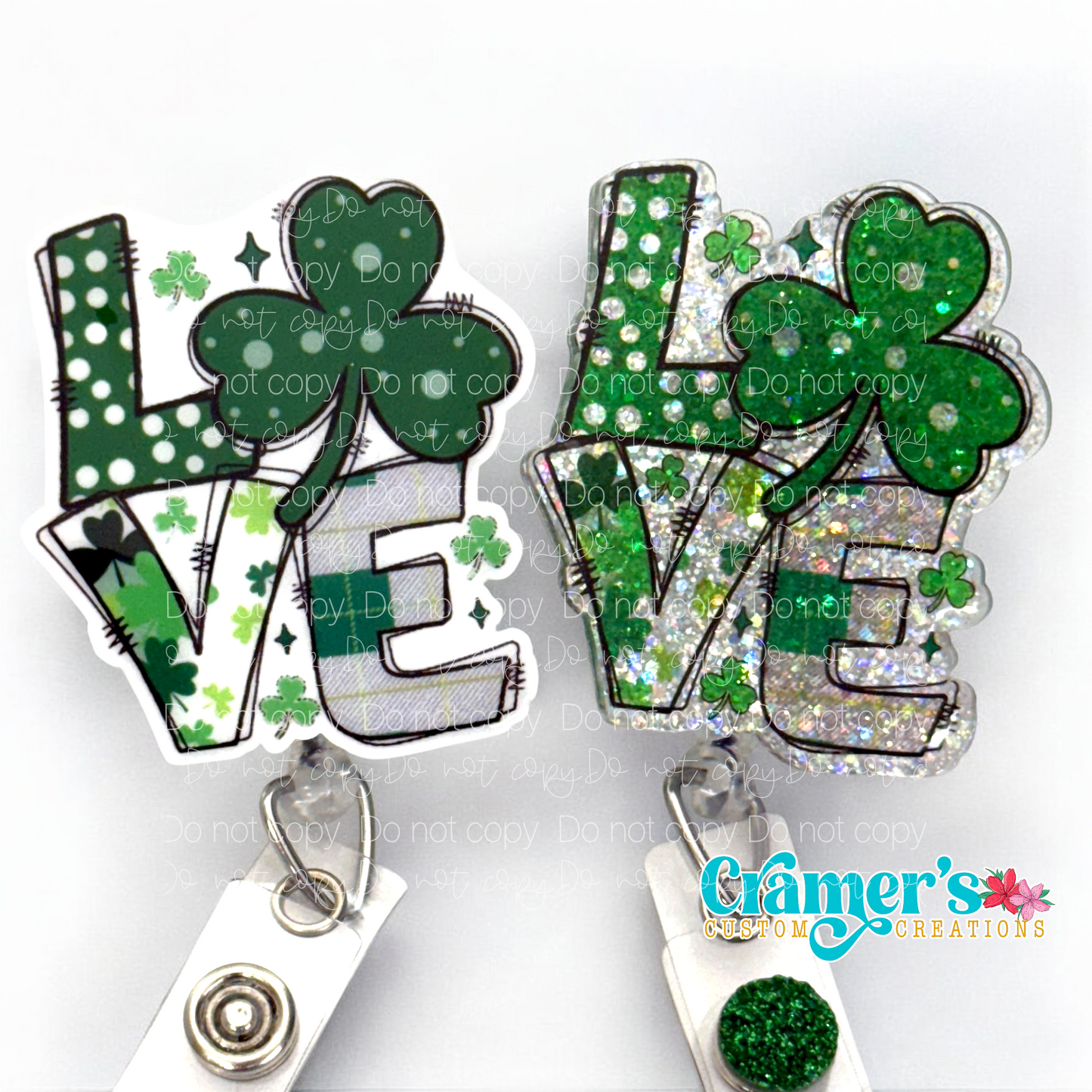 2 badge reels showing a glitter and a non glitter option of a badge with the word love with a shamrock being the O