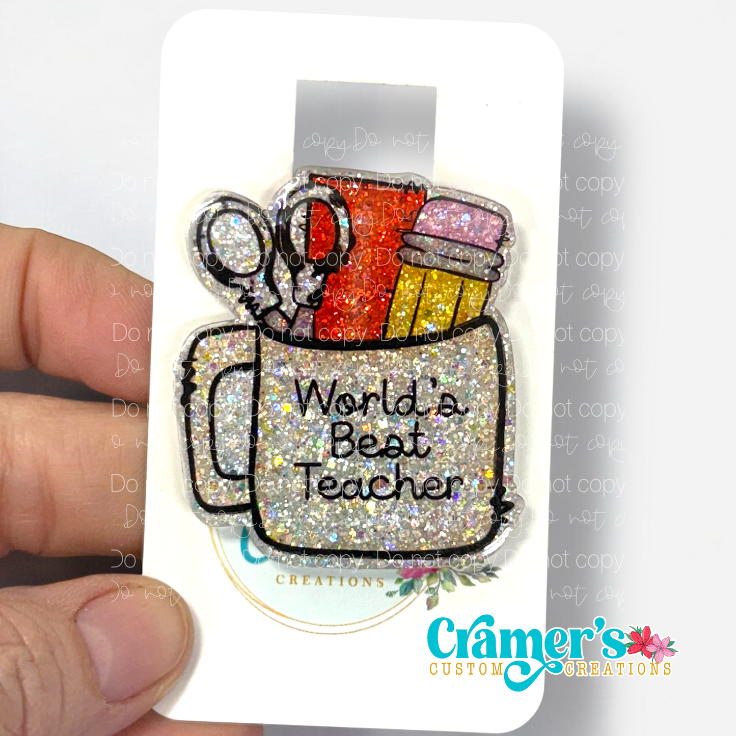 badge reel showing a glitter option of a badge with a coffee mug filled with teacher items and the words worlds best teacher