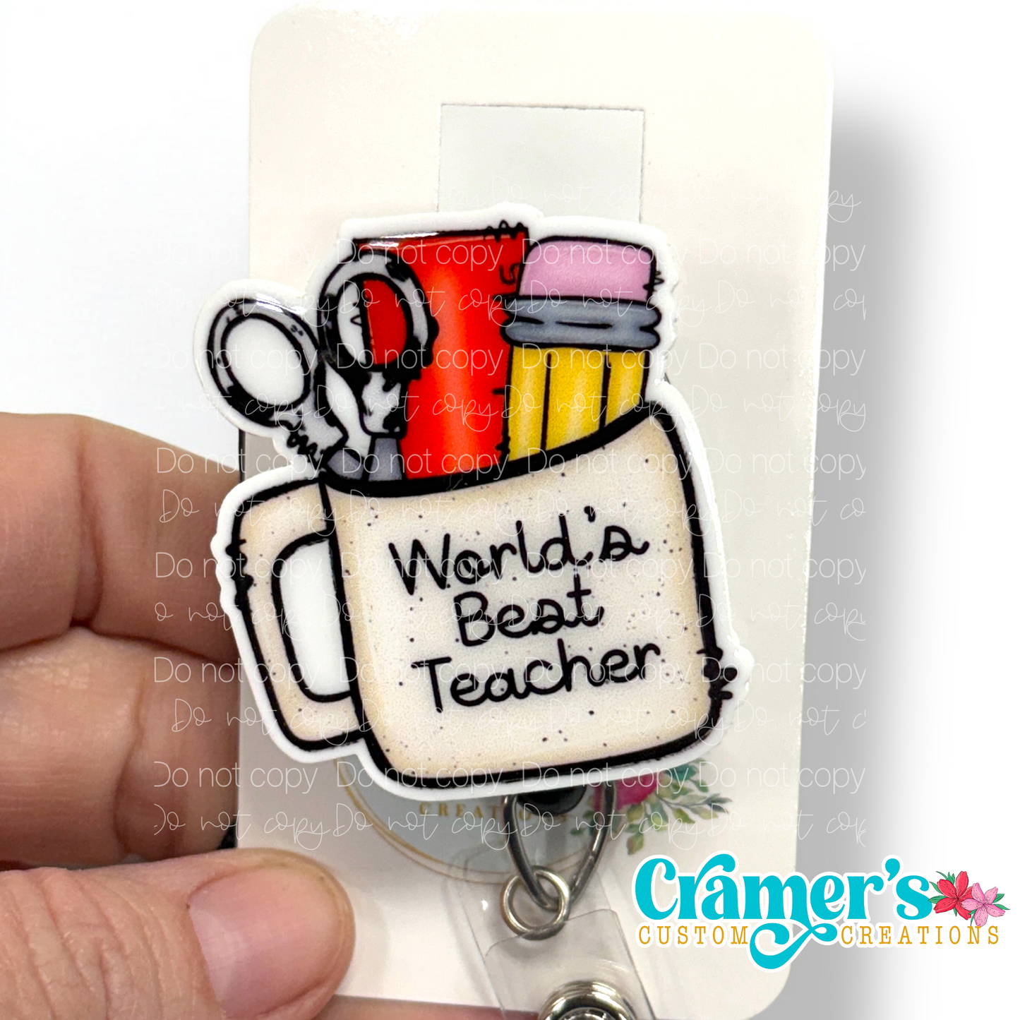 badge reel showing a non glitter option of a badge with a coffee mug filled with teacher items and the words worlds best teacher