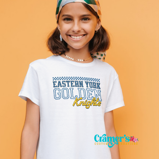 A young person wearing a white t-shirt with 'Eastern York Golden Knights' text printed on the front.