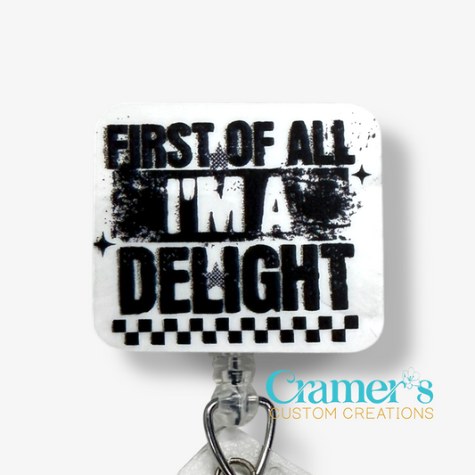 Decorative tile with text 'First of all I'm a delight' and Cramer's Custom Creations logo.