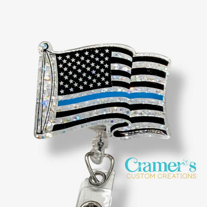 American flag badge holder with thin blue line on a white background, featuring Cramer's Custom Creations branding.