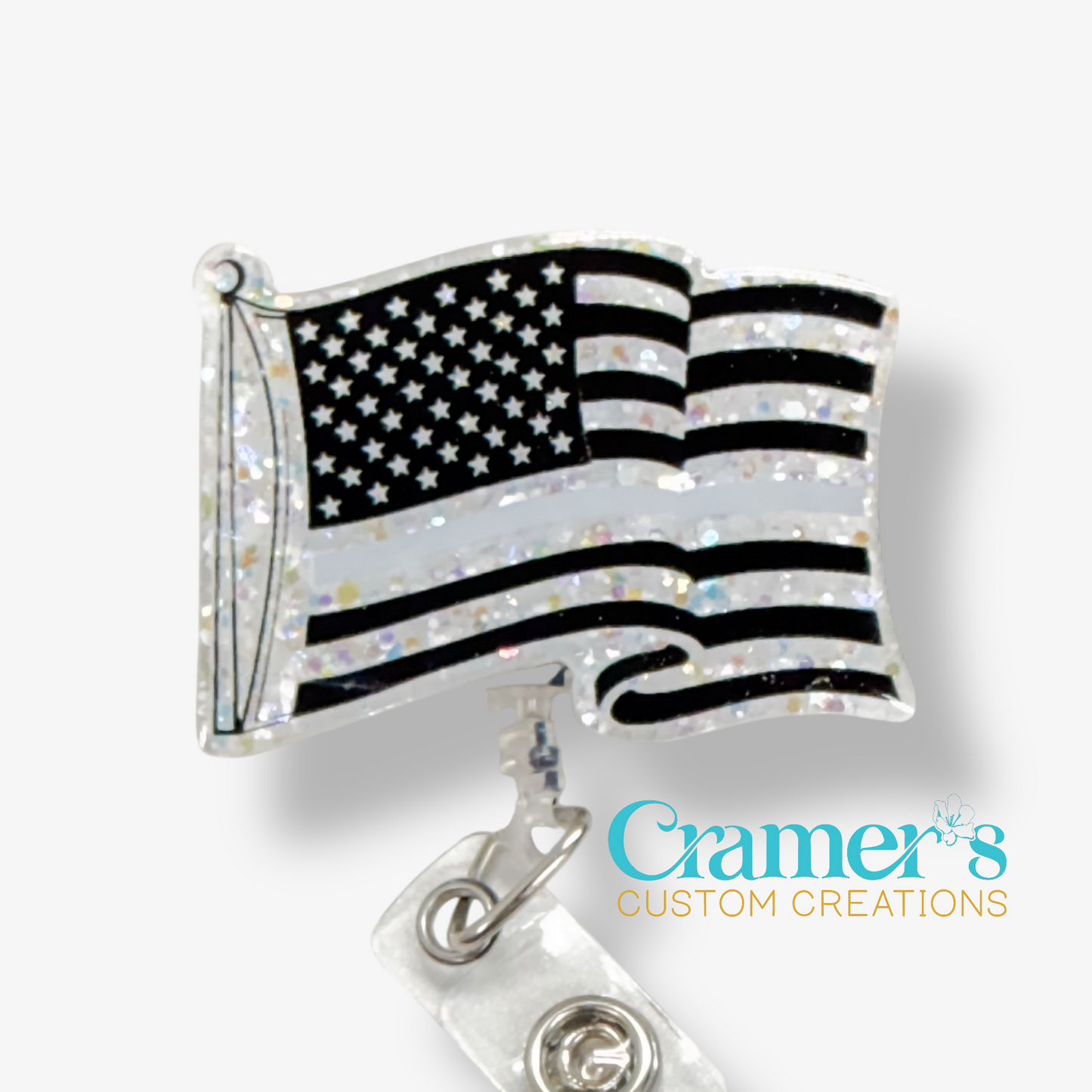 American flag badge reel with 'Cramer's Custom Creations' logo on a white background