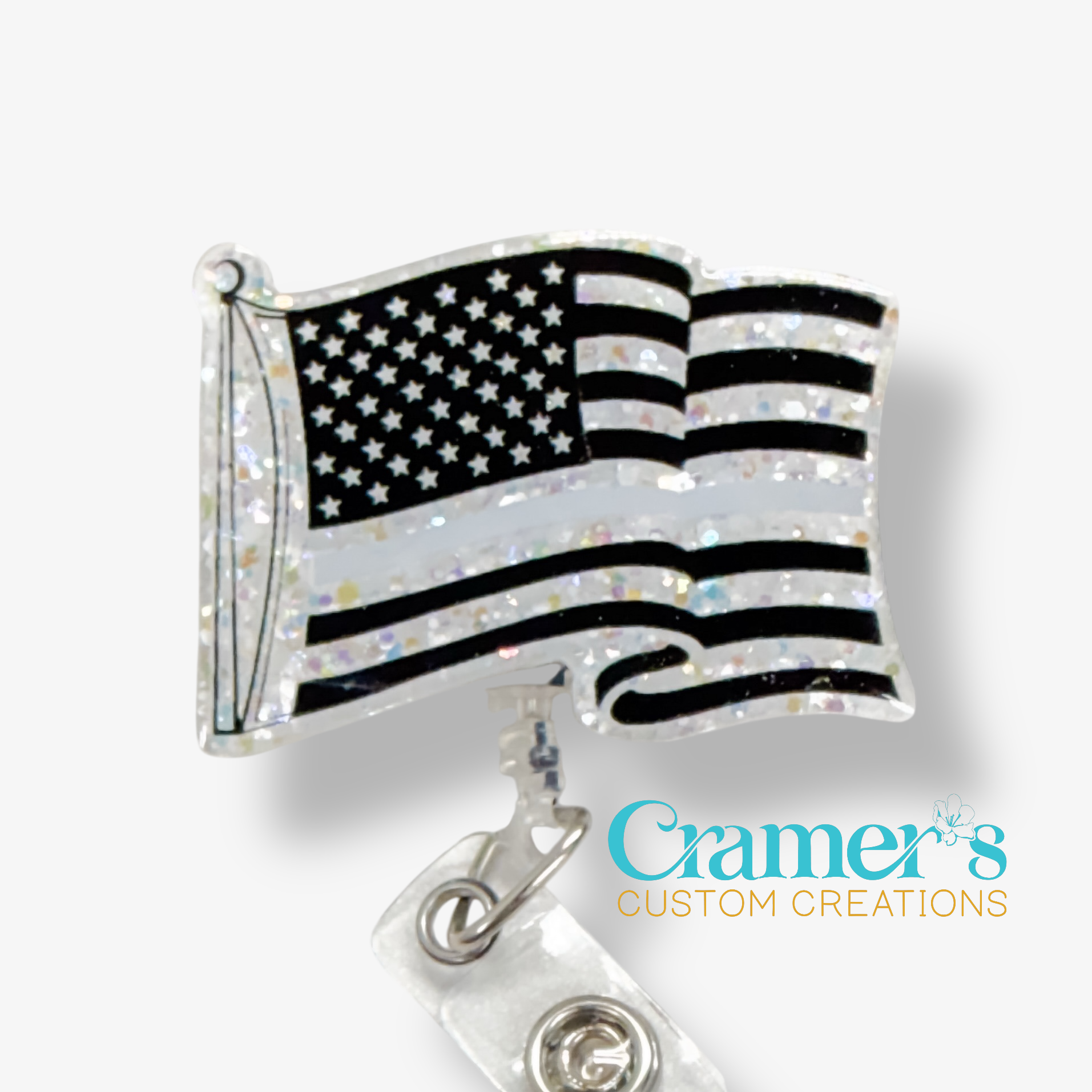 American flag badge reel with 'Cramer's Custom Creations' logo on a white background