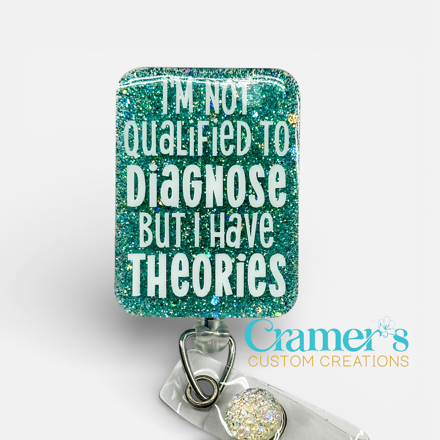 Glittery badge holder with text 'I'm not qualified to diagnose but I have theories' by Cramer's Custom Creations.