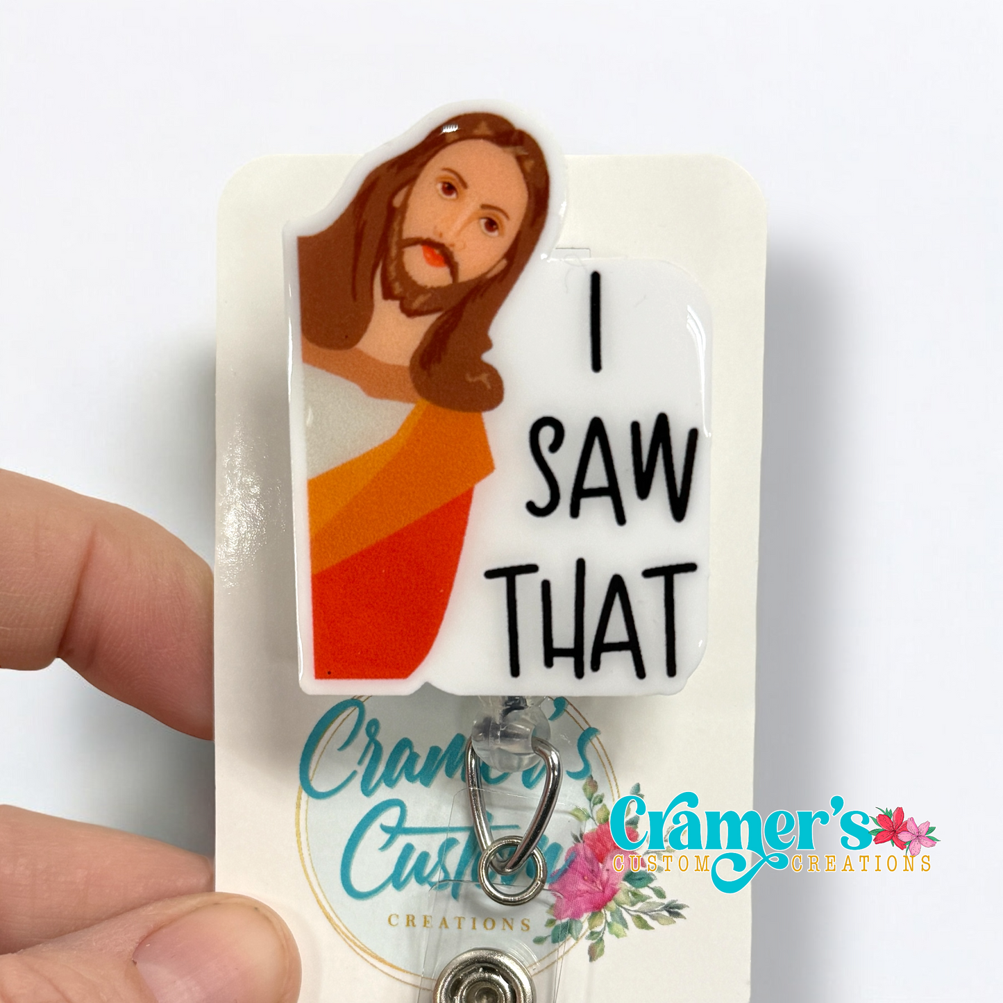badge reel showing a non glitter option of a badge with Jesus peeking around the corner and the text says I saw that