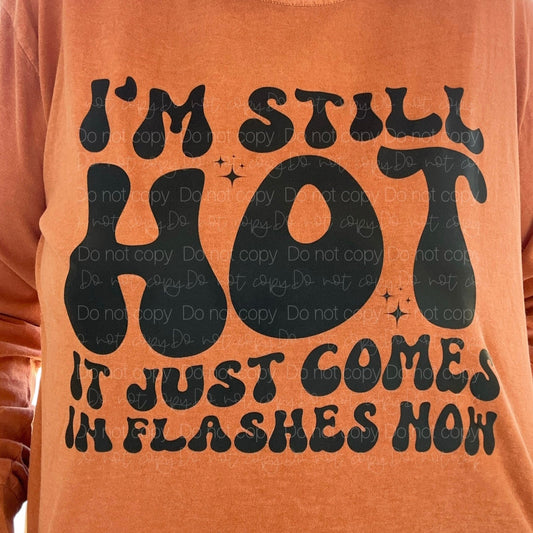 orange tshirt with text 'i'm still hot it just comes in flashes now' in retro style text