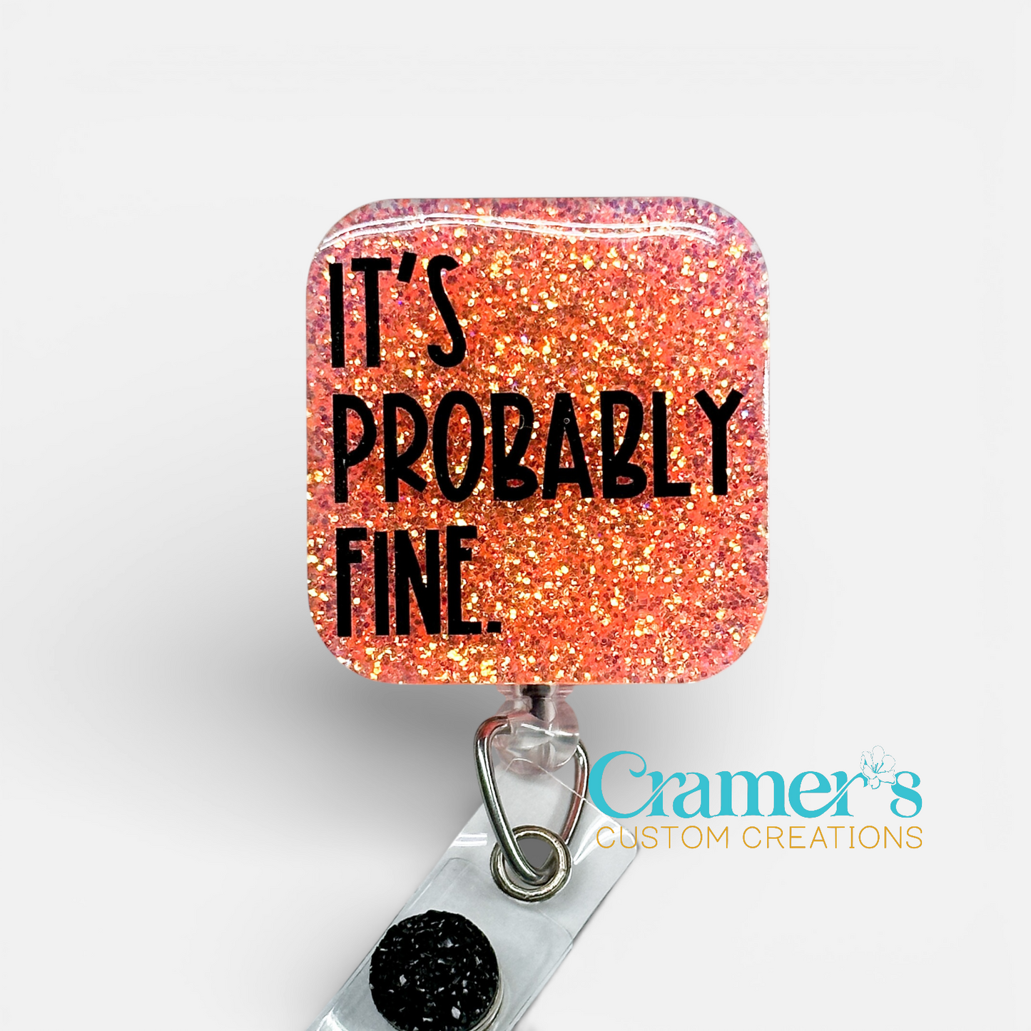 Glittery badge holder with 'It's Probably Fine' text on a white background, featuring Cramer's Custom Creations logo.
