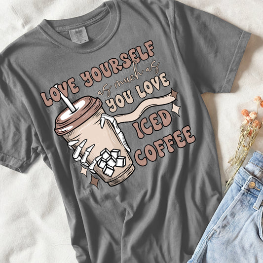 flat lay of a grey shirt that says love your self as much as you love iced coffee 