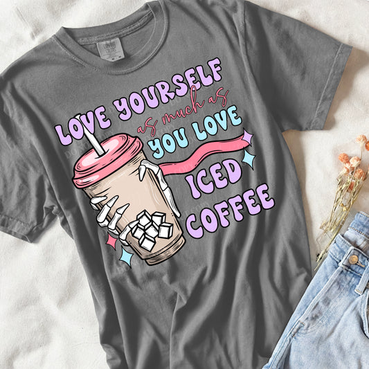 a grey shirt laying flat with a pair of jeans.  it says love yourself as much as you love iced coffee with a skeleton hand holding an iced coffee