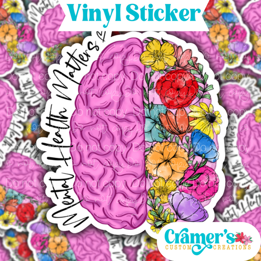 A vinyl sticker with a design of a brain and flowers, with the text 'Mental Health Matters' on it.