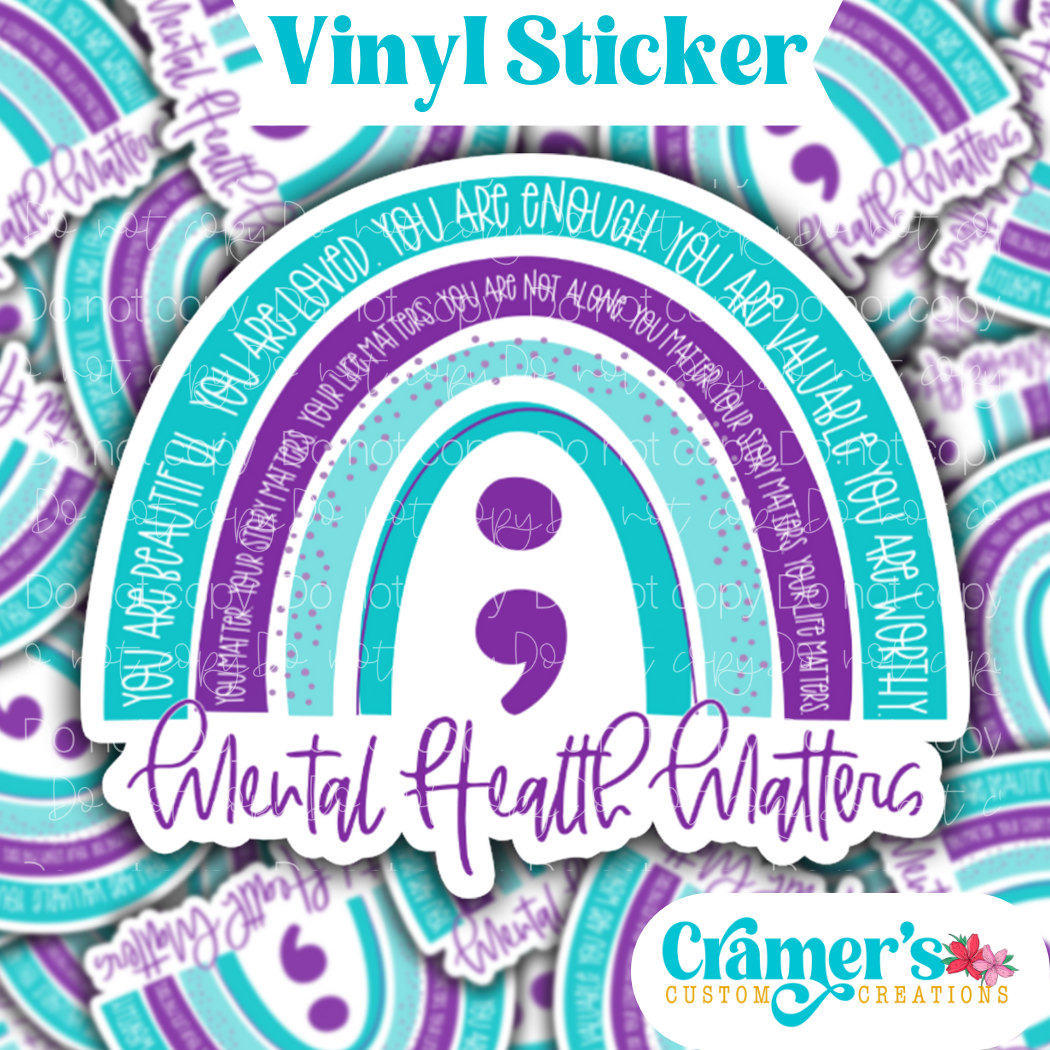 Sticker laying flat that says mental health matter with a rainbow and semi colon in a purple and teal theme, on a background of the same sticker stacked 