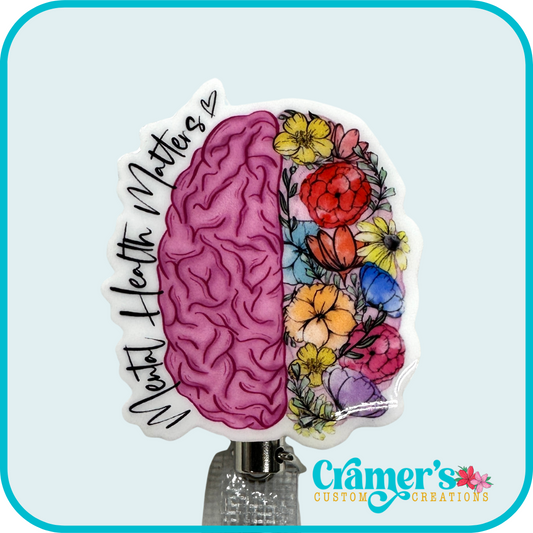 non glitter pink brain with flowers on the right side and mental health matters along the left side