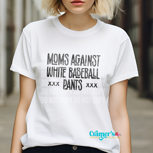 A person wearing a white t-shirt with the text 'Moms Against White Baseball Pants' printed on the front.