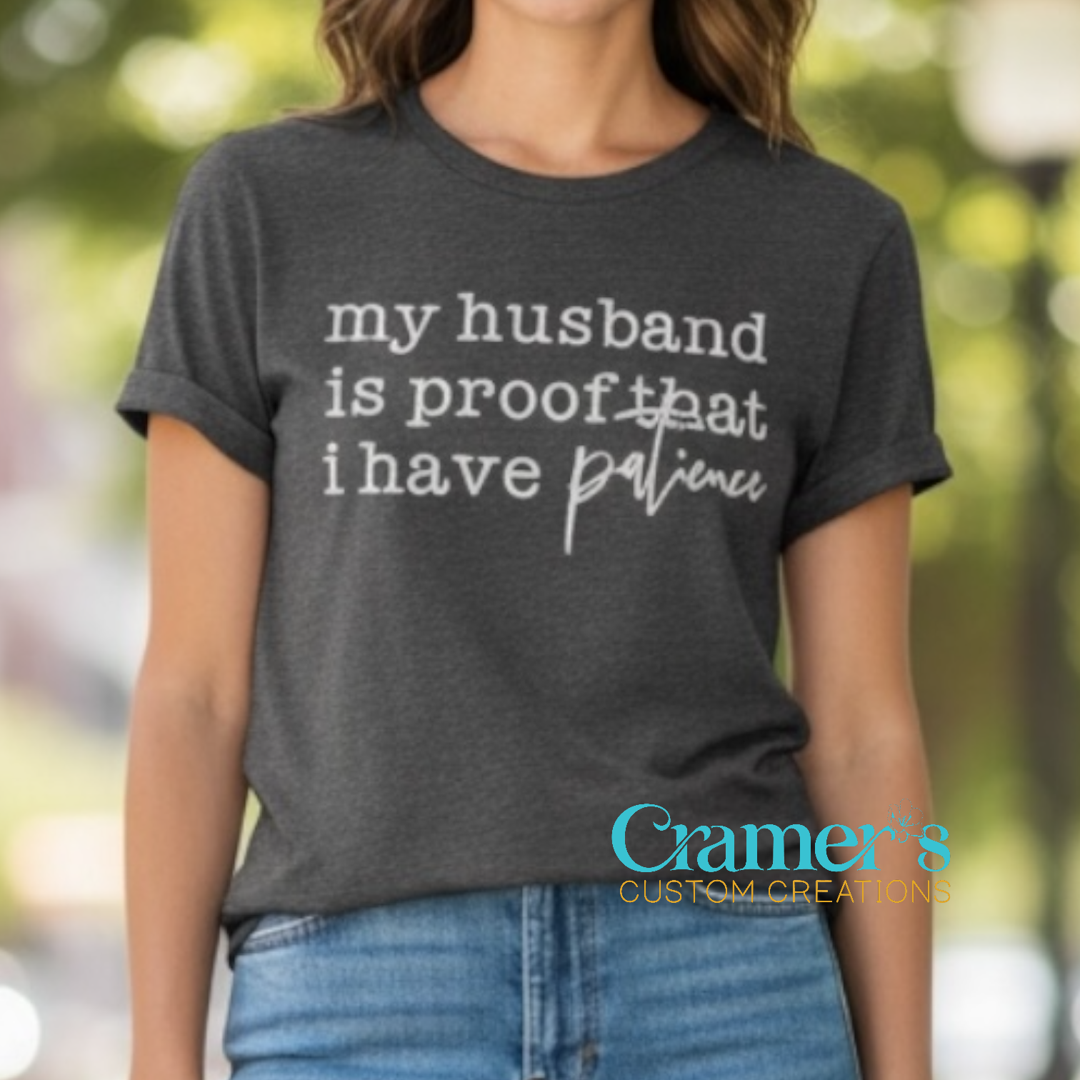 female wearing a grey shirt that says 'my husband is proof that I have patience' 