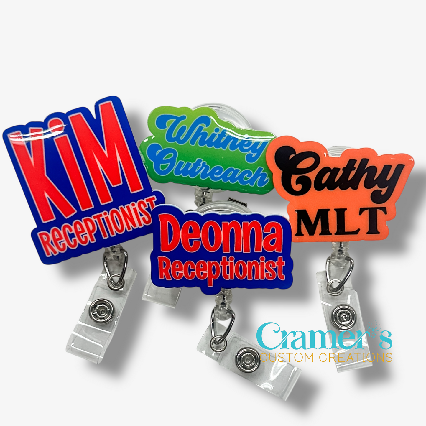 Colorful name badge holders with personalized names and titles on a white background.