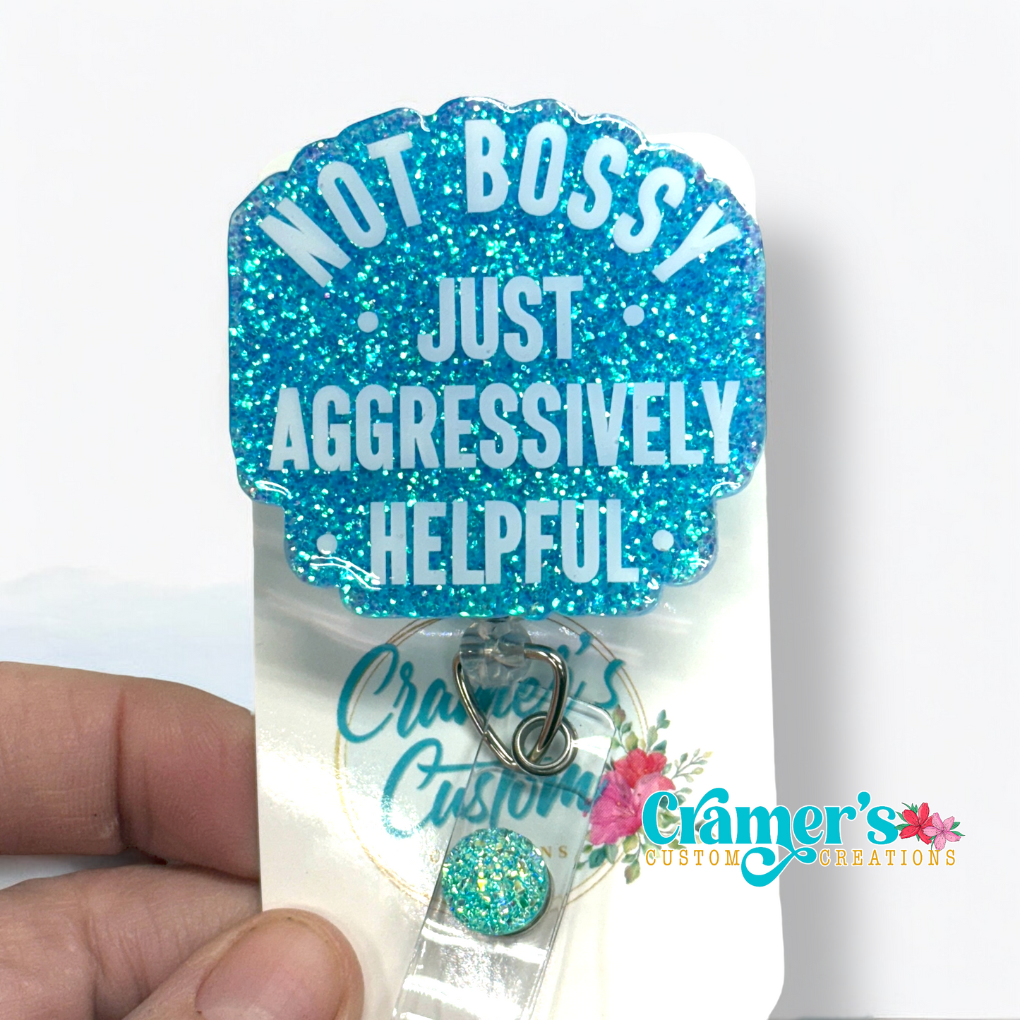 badge reel showing a blue glitter background with not bossy just aggressively helpful in white