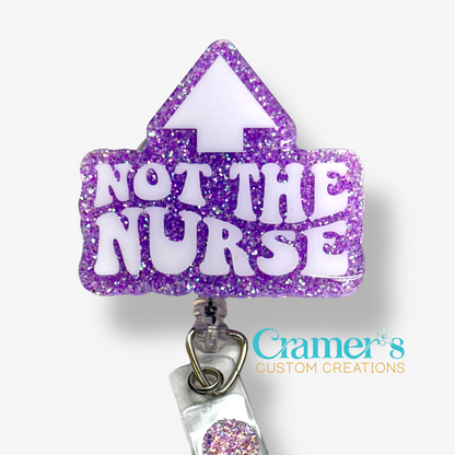 badge reel showing a purple glitter background with not the nurse in white with an arrow pointing up