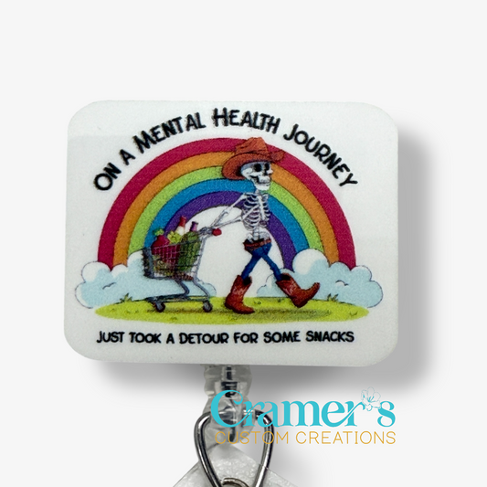 Skeletal figure with a shopping cart under a rainbow, text 'On a Mental Health Journey, took a detour for snacks', Cramer's Custom Creations logo.