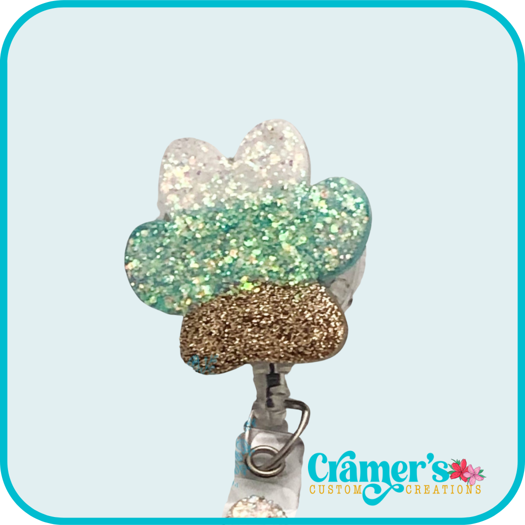 glitter paw print with white, teal, and gold