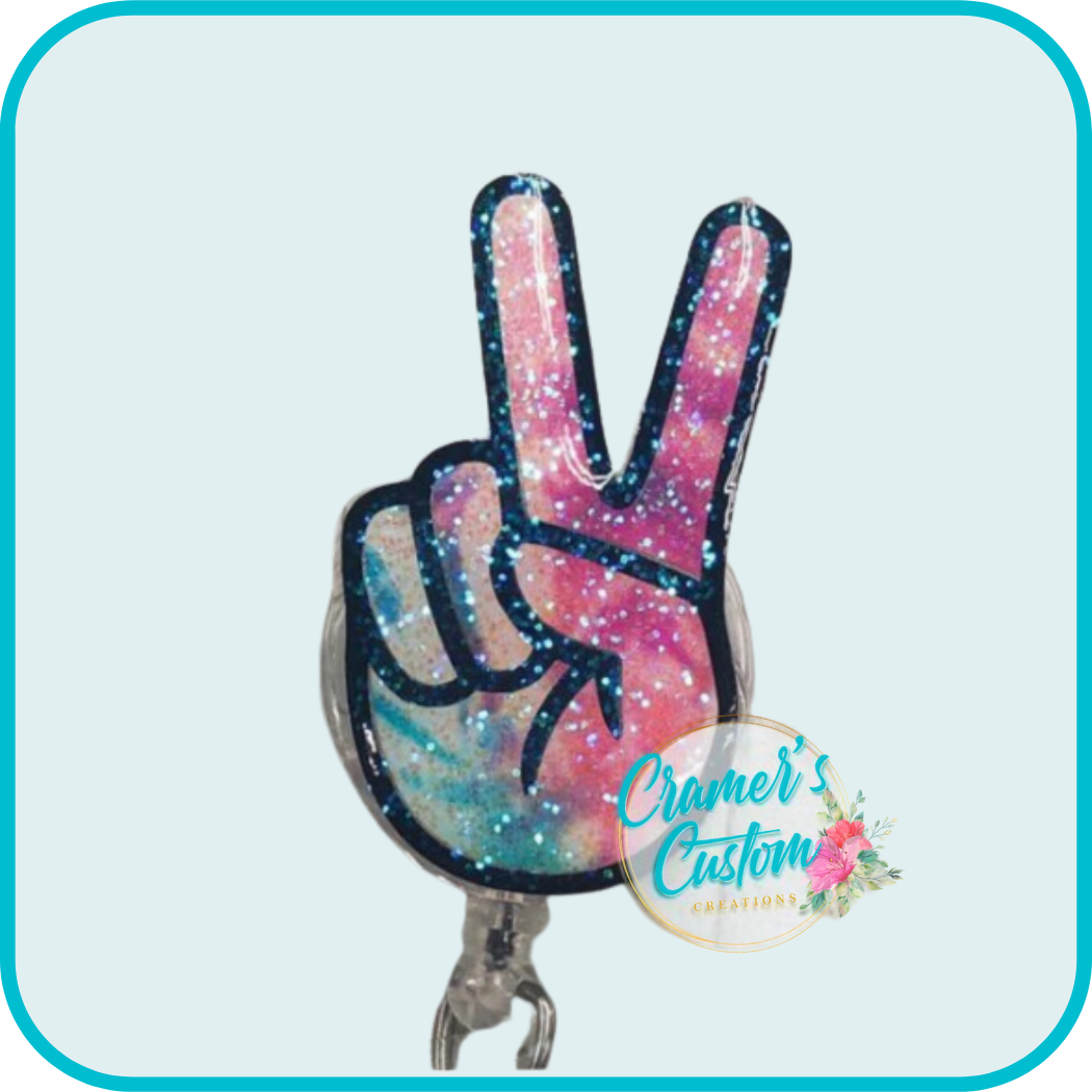 finger peace sign with a pastel tie dye  design and a light glitter coating