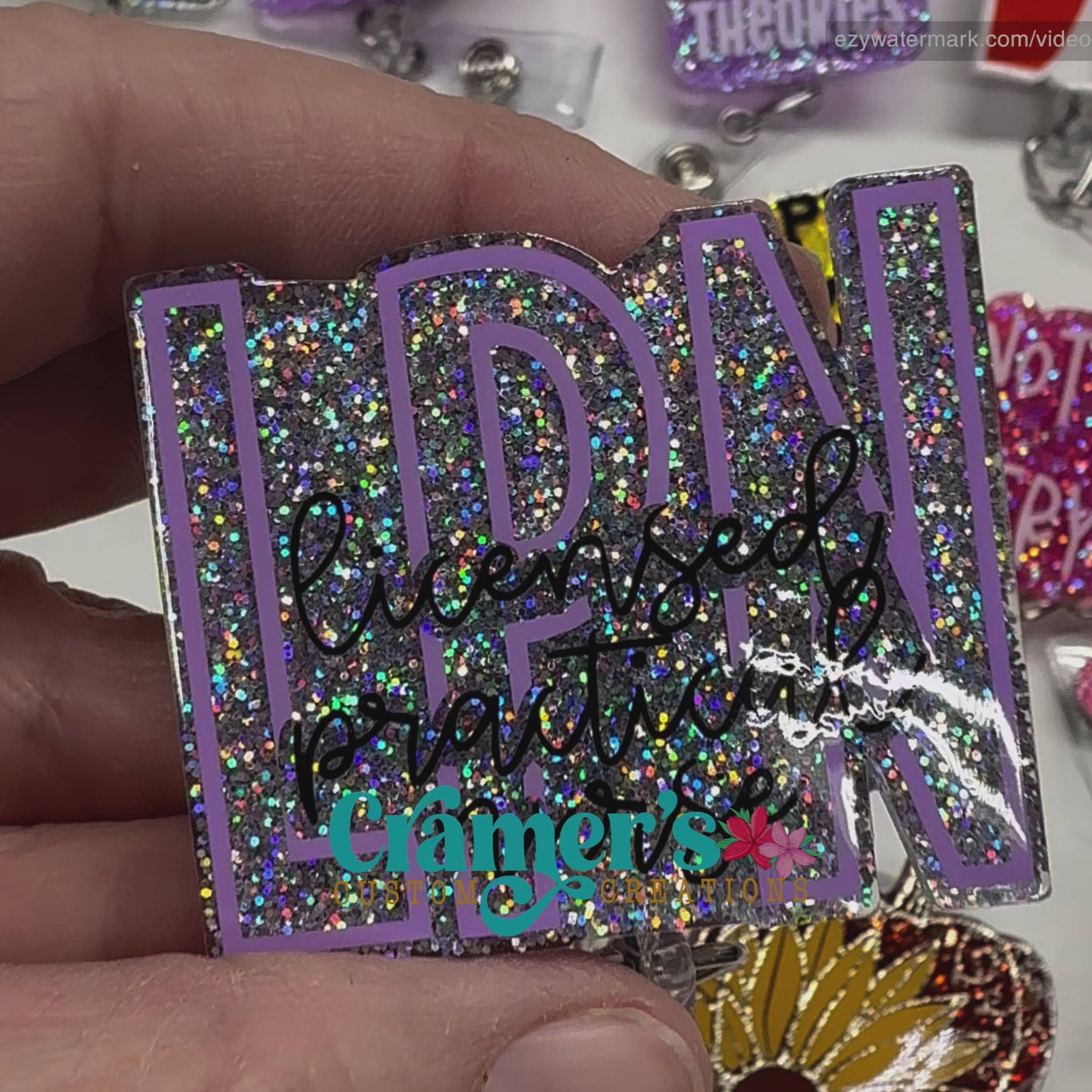 video of badge reel showing a silver glitter background with the initials in purple and licensed practical nurse in black