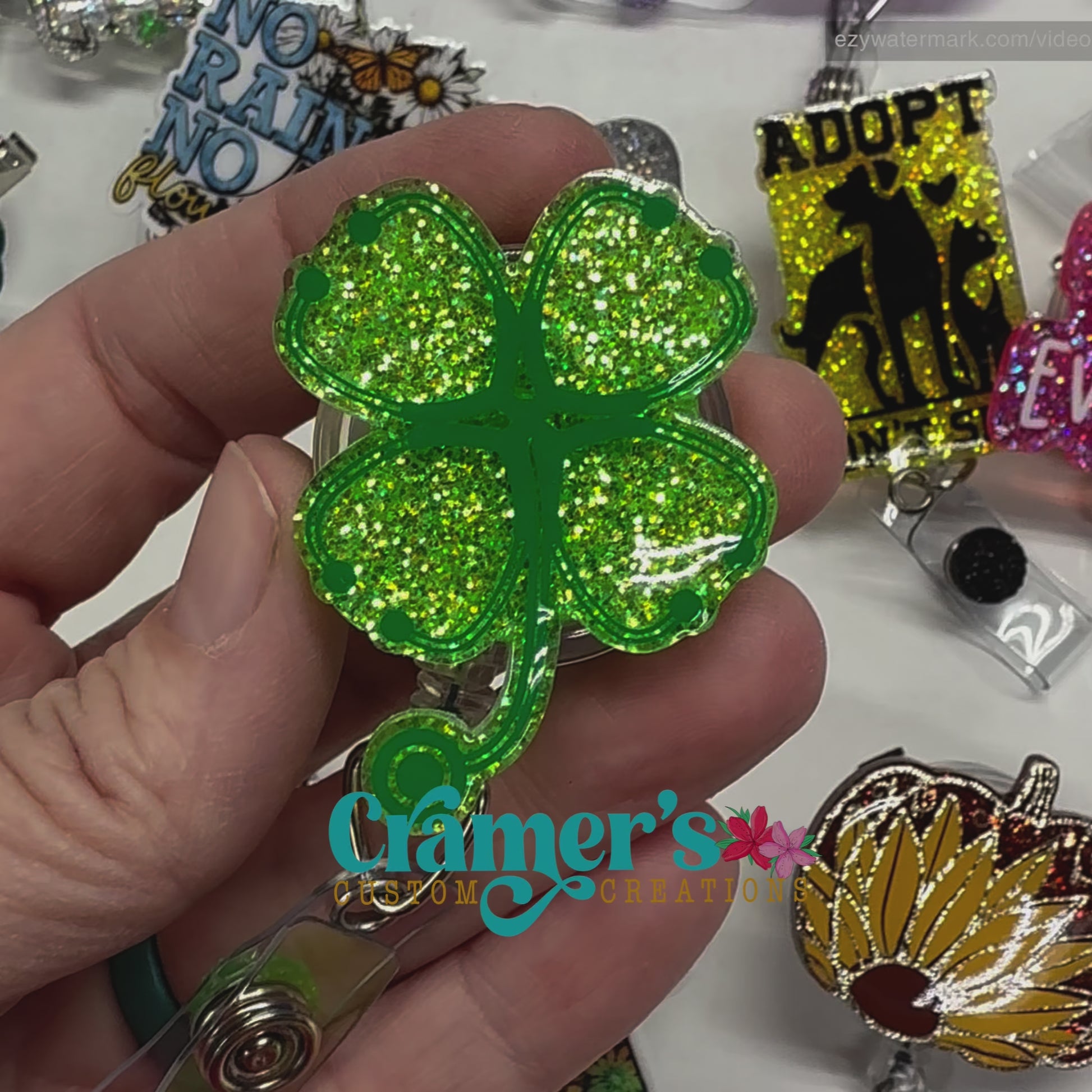 video of badge reel showing a green glitter background with stethoscopes made into a shamrock in darker green vinyl