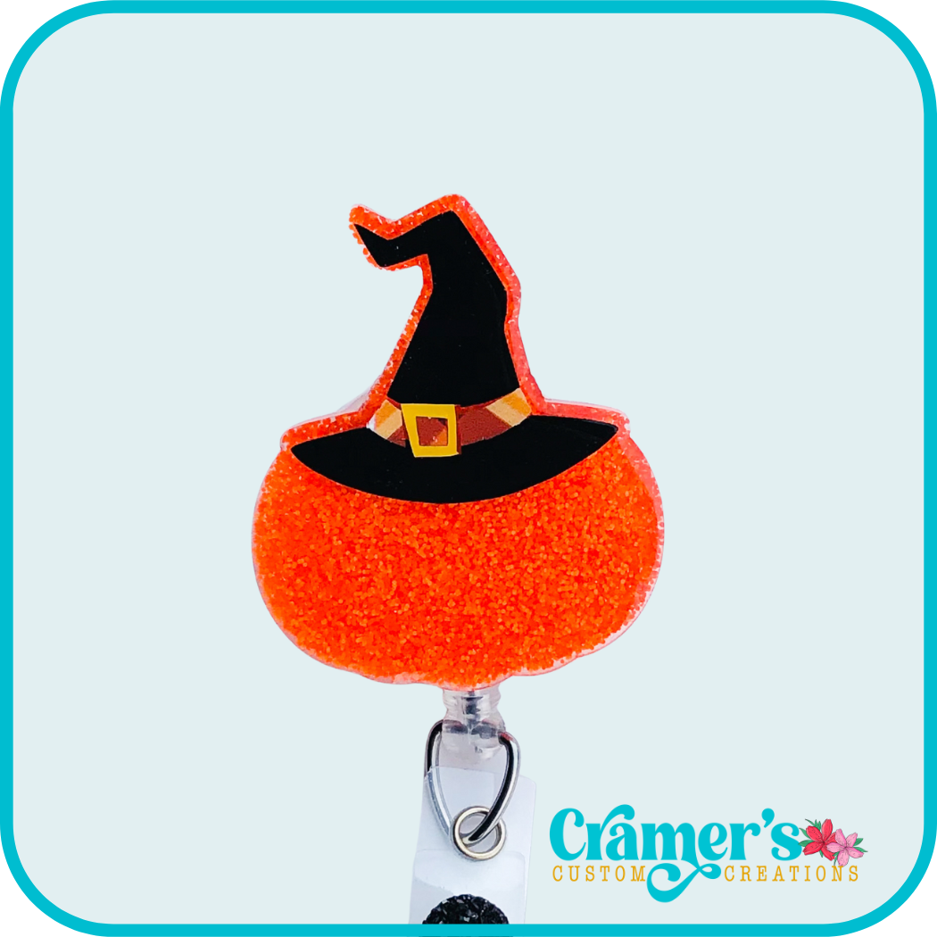 glittery orange pumpkin with a witch hat