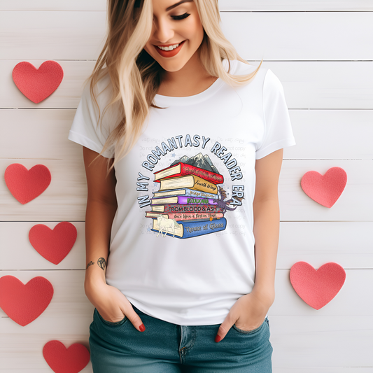 A person wearing a white t-shirt with a graphic print of stacked books and the text 'In My Romantasy Reader Era'.