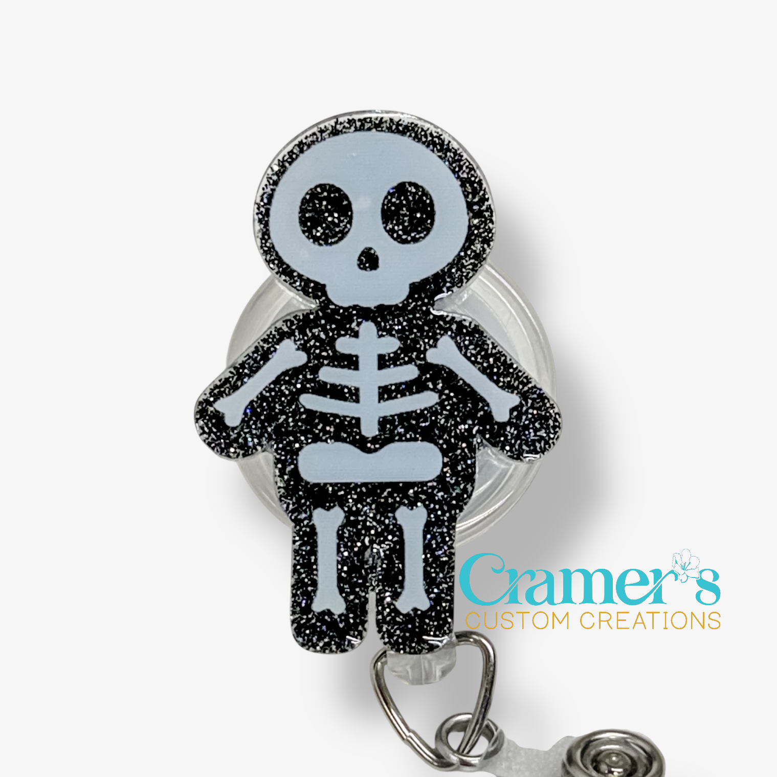 Skeleton design badge holder with glittery black and blue finish on a white background, featuring 'Cramer's Custom Creations' branding.