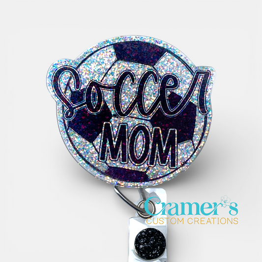 Glittery 'Soccer Mom' badge holder with Cramer's Custom Creations logo on a white background