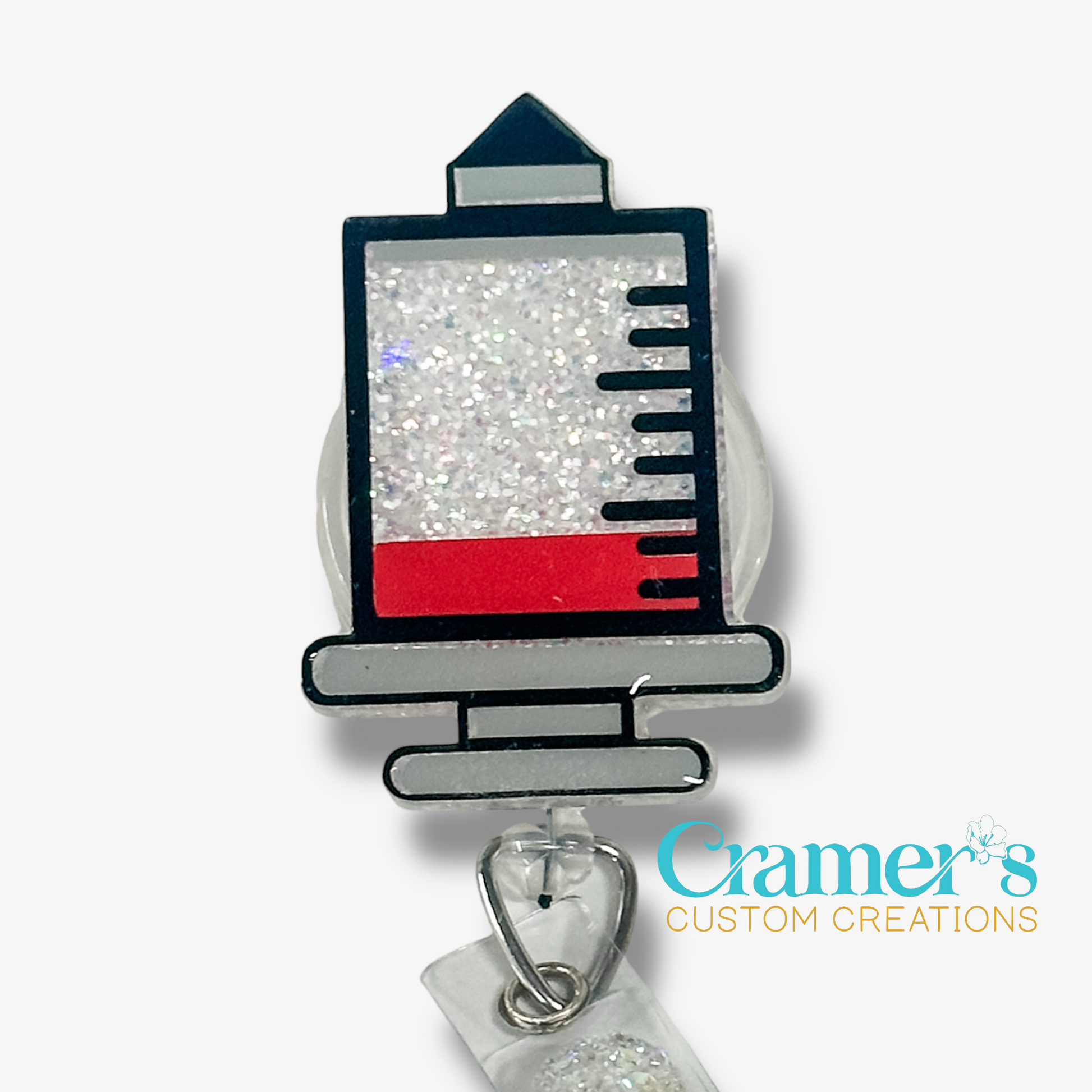 Decorative syringe-shaped badge holder with red and silver design on a white background, featuring 'Cramer's Custom Creations' branding.