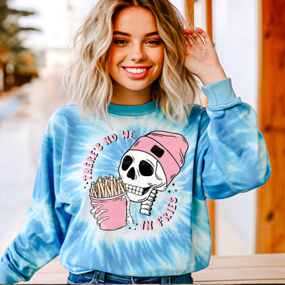 A person wearing a blue tie-dye sweatshirt with a graphic print of a skull holding a pink cup and the text 'There's no WE in Fries'.