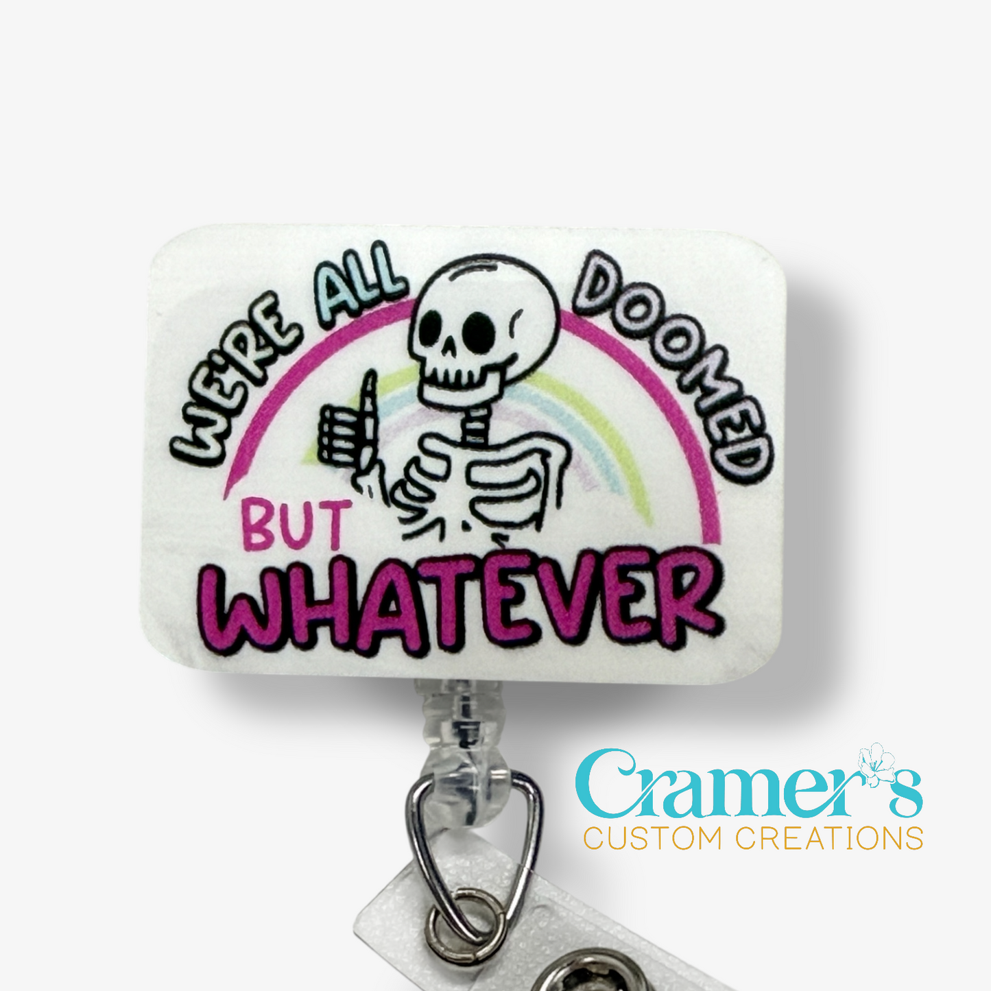 Sticker with skeleton design, rainbow, and text 'We're all doomed but whatever' on a white background with 'Cramer's Custom Creations' logo.