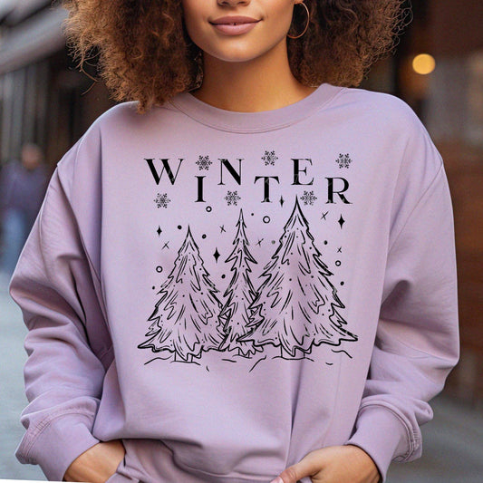 A woman wearing a purple sweatshirt with a winter-themed graphic design, featuring pine trees and the word 'WINTER'.