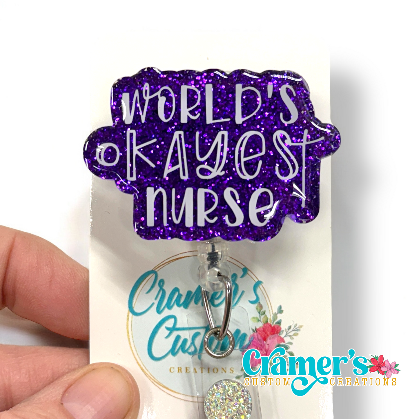 badge reel showing a purple glitter background with world's okayest nurse in white