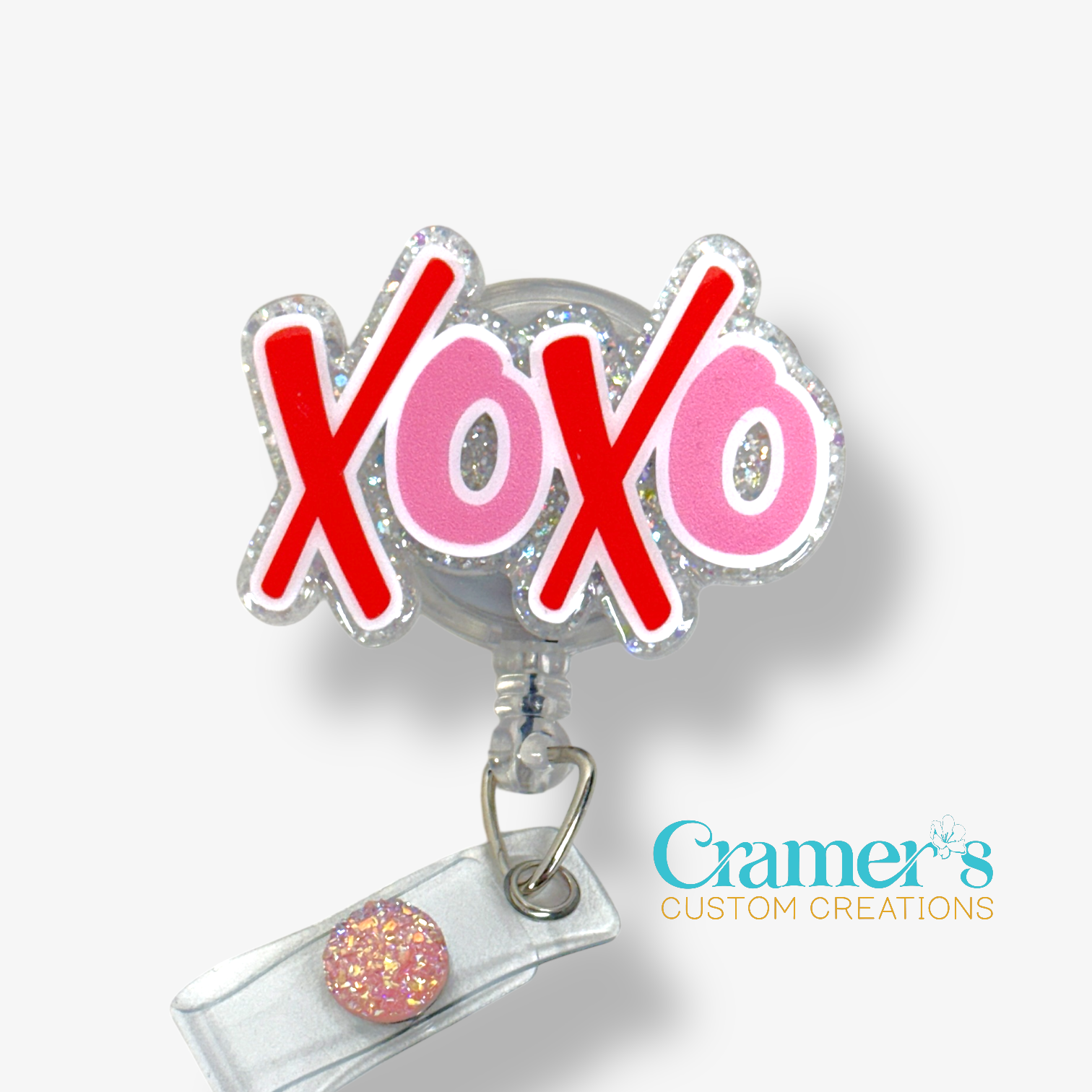 Badge holder with 'XOXO' design and Cramer's Custom Creations logo.
