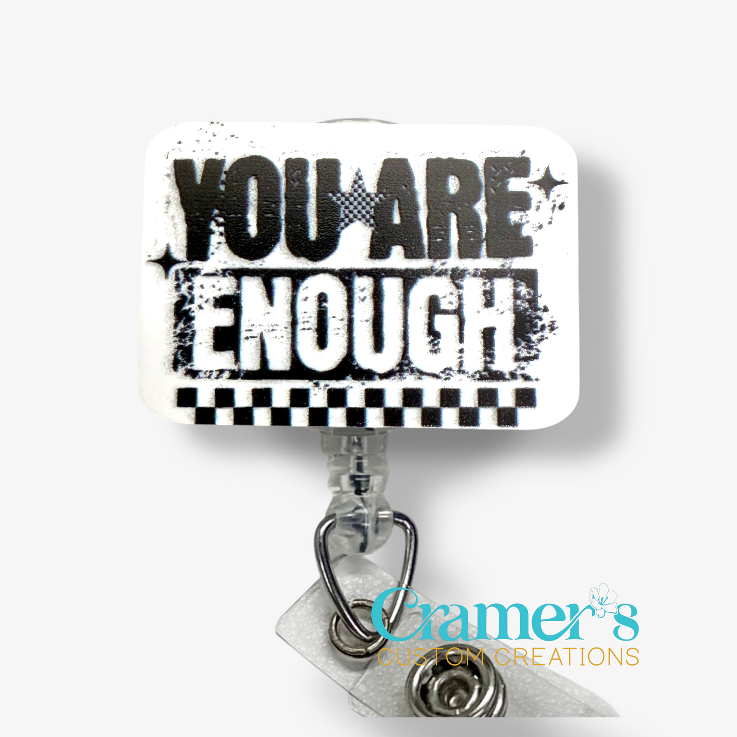 Motivational quote 'YOU ARE ENOUGH' on a badge reel topper with 'Cramer's Custom Creations' branding.