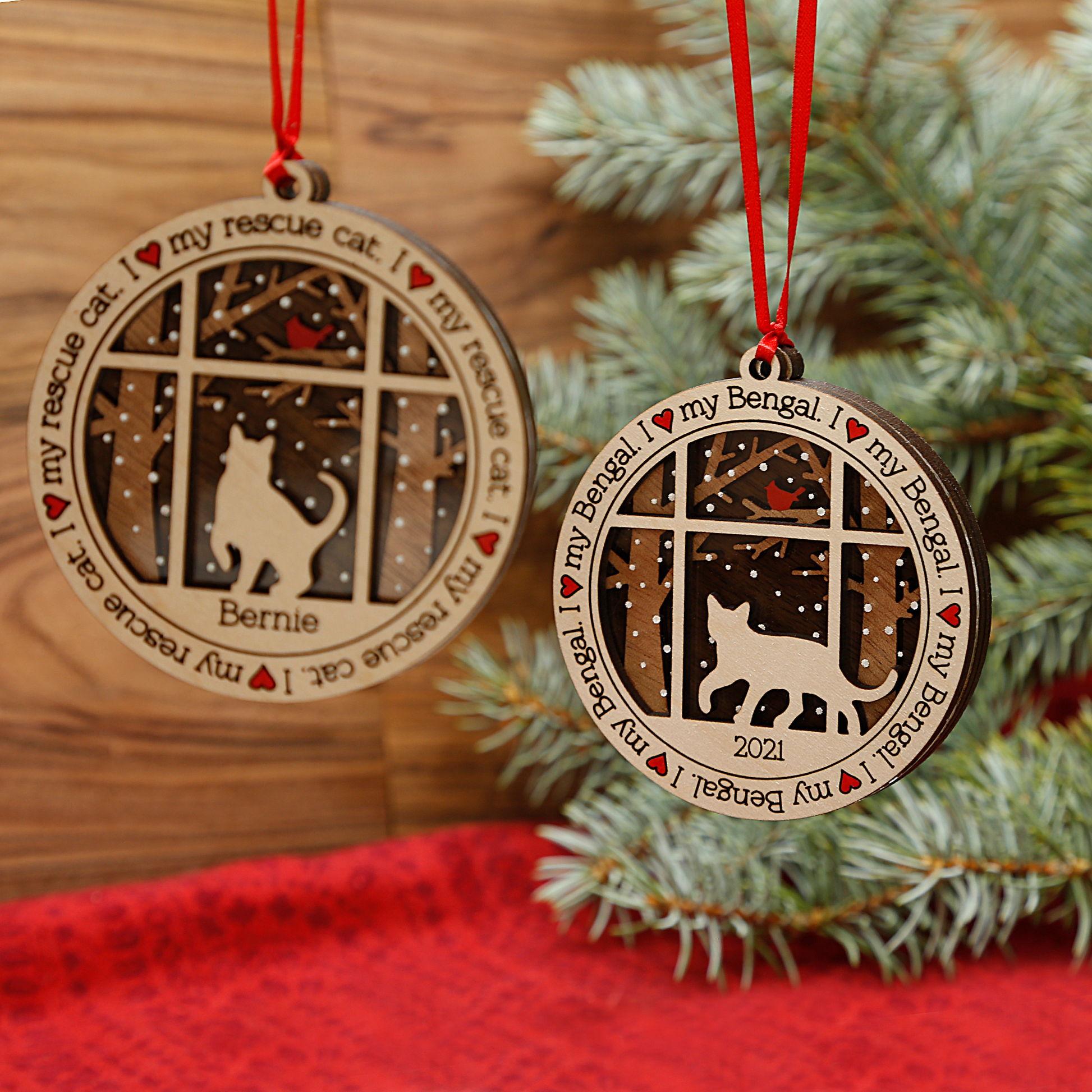 wood cat ornaments hanging with a tree in the background