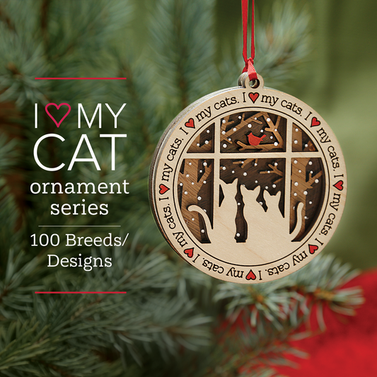 A round wooden ornament with a Christmas tree design, featuring silhouettes of cats and text that says 'I Love My Cat Ornament Series 100 Breeds / All Designs'.