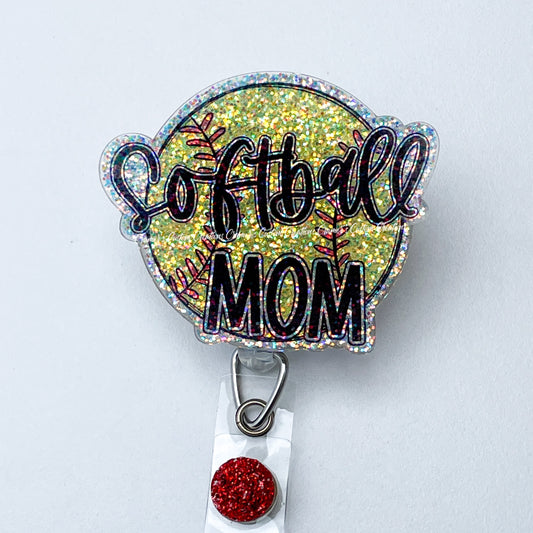 a sparkly badge reel with a softball, that says softball mom on a white background
