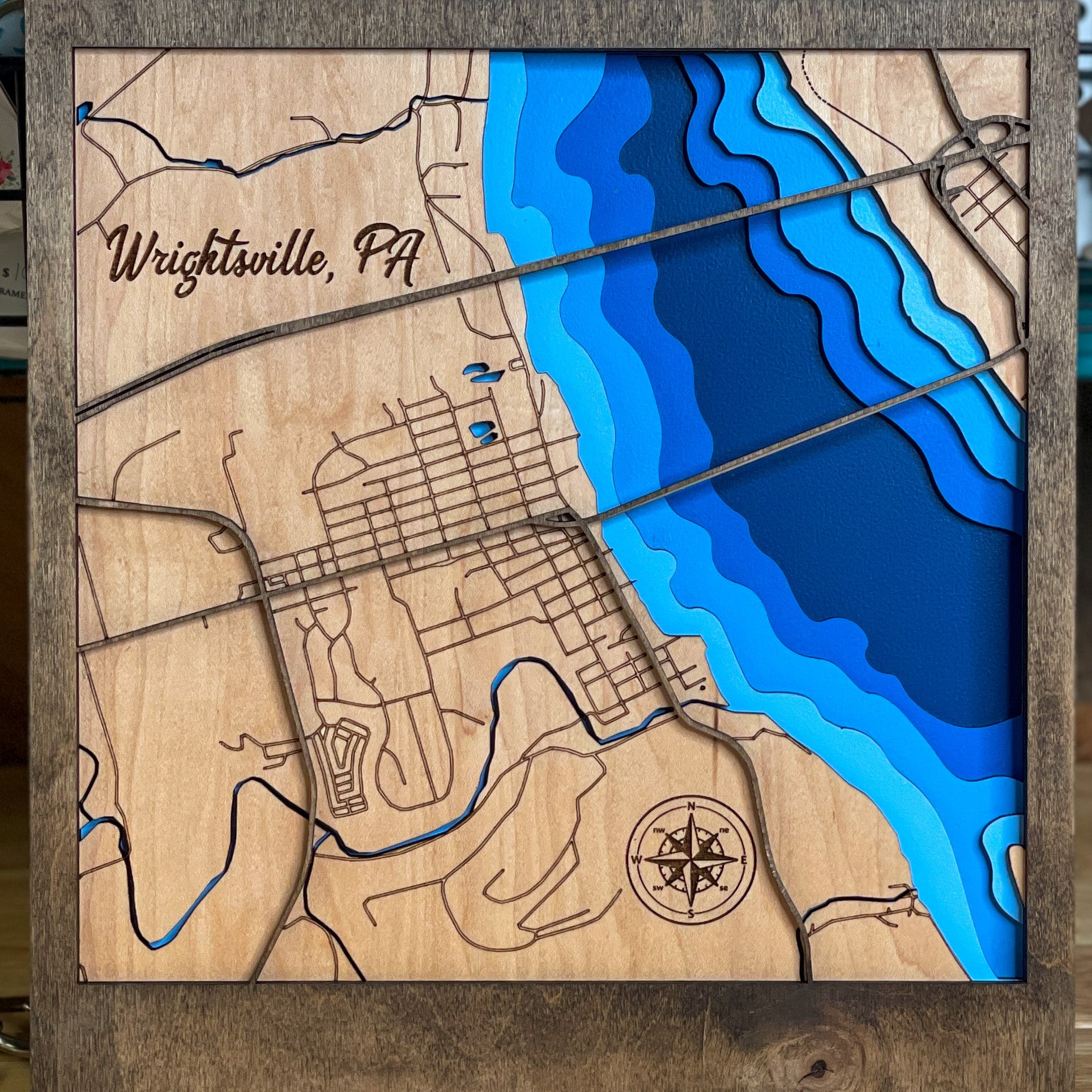Wood multi layered map of wrightsville pa painted to show river depth and the streets in the town