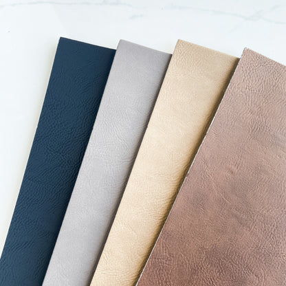 4 sheets of different colored leather on a white background