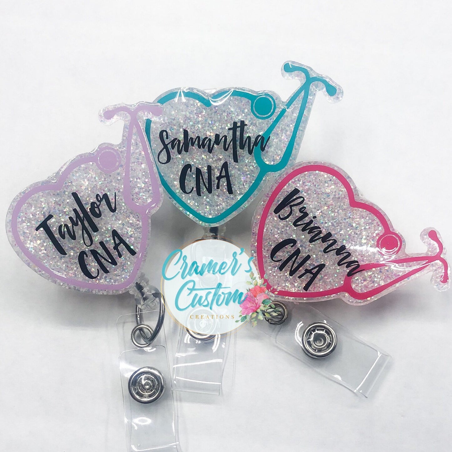 three white hearts with stethoscopes wrapped around them and names and titles in the middle on a white background