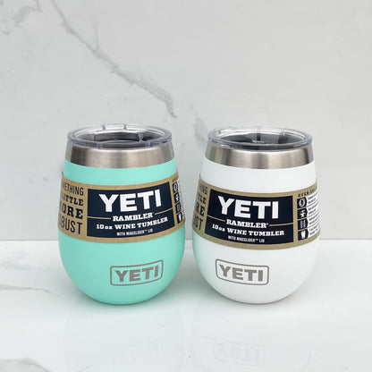 Two yeti wine tumblers, one teal and one white on a white background